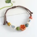 Handmade ceramic bead bracelet with charming flower design, new Chinese style woven cord jewelry. - Flat Flower Slices, Orange