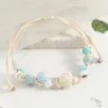 Handmade braided cord bracelet featuring blue beads and a cute ceramic turtle pendant. - Turtle Blue Style