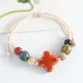 Handmade Jingdezhen ceramic beaded bracelet with traditional Chinese clover design for women. - Four-Leaf Clover (Orange)