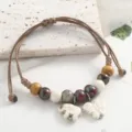 Artistic Chinese style ceramic beaded bracelet with cute elephant and butterfly charms for women. - Elegant Auspicious Elephant