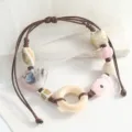 Handmade woven ceramic bracelet featuring cute fish and shell beads with a wooden ring variant. - Wooden Ring Koi Fish