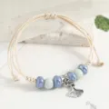 Ceramic beaded woven bracelet with silver ginkgo leaf charm, elegant minimalist style for women. - Sea Blue Abacus Beads Fishtail