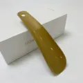 Portable plastic shoehorn with hanging hole, durable daily shoe helper tool for home use. - Pure Gold
