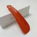 Orange plastic shoehorn with hanging hole, portable helper for daily home use, elderly and pregnant. - Orange Red