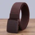 Detail shot of a brown tactical nylon belt with durable plastic buckle for outdoor sports. - Coffee