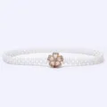 Close-up of the delicate gold rhinestone flower buckle and pearl beaded elastic belt. - 7