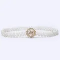 Close-up detail of the elegant pearl waist belt featuring a sparkling crystal flower buckle. - 17
