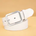 White PU leather belt detail close up, featuring a simple silver square pin buckle design. - White