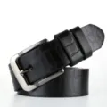 Close-up view of a black embossed crocodile pattern men's leather belt with metal buckle. - 115cm / Black