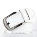 Close-up detail of the white PU leather belt with dark metal pin buckle, fine stitching. - White