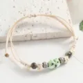 Beige woven cord bracelet featuring a cute green ceramic frog bead and colorful decorative beads. - Playful Little Frog Beads