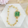 Detail shot of a square green dial watch with gold chain link strap, elegant design. - Gold Green