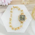 Detailed close-up of luxurious gold square watch with stylish paperclip link bracelet design. - Gold Black