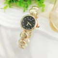 Elegante Damen Quarzuhr mit glitzernden Strasssteinen, schwarzem Zifferblatt und Armband. - Gold Schwarz