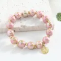 Bracelet en perles de céramique rose de Jingdezhen avec entretoises dorées et charm variante. - 10mm / Rose Rouge Vert
