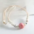 Chinese style ceramic rose bracelet with white crackled beads and adjustable beige cord variant. - Copper Coin Rose Pink