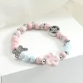 Charming ceramic beaded bracelet with pink and blue beads, cute flower and butterfly charms for daily wear. - Hua Jian Jing