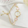 Detail view of women watch featuring pink star and moon charms on gold pull chain bracelet. - Drawstring Style (2026310) / Gold Pink