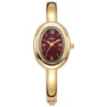 Elegante goldfarbene Damen Armreif Uhr mit ovalem rotem Zifferblatt und romischen Ziffern. - Goldrot
