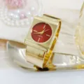 Luxury minimalist gold bangle watch for women with stylish red dial. Elegant fashion quartz timepiece. - Gold Red