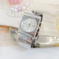 Silver cuff watch close up, elegant square case quartz timepiece with metallic strap. - Silver White