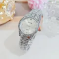 Detailed shot of a luxury women rhinestone quartz watch with sparkling crystals and silver band. - Silver