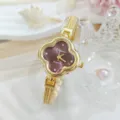 Vista ravvicinata di un orologio donna quarzo quadrifoglio con cinturino in oro e strass. - Rosso Oro