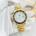 Close-up view of the gold-tone steel quartz watch detail, featuring a white dial and date window. - Gold White