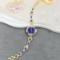 Elegante orologio da polso da donna con gemma blu e cinturino dorato per moda di lusso. - Blu
