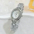 Detail shot of silver-tone rhinestone oval quartz wristwatch with elegant bracelet strap. - Silver White