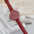 Red leather strap quartz watch for women with rhinestone markers and flower dial design. - Red