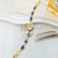 Vintage style gold women quartz watch detail featuring blue oval gemstone bracelet design. - Gold Tone with Blue Marble Stone