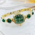 Detailansicht der goldenen Damenuhr mit grünem Zifferblatt und Edelsteinarmband, Nahaufnahme. - Grün