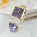 Elegante quadratische Quarzuhr mit lila Zifferblatt und grossem Kristallstein am goldenen Armreif. - Gold Violett