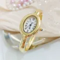 Vintage gold oval quartz bangle watch for women with Roman numerals and elegant bracelet strap. - Regular Fit / White