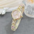 Close-up detail of luxury women rhinestone quartz watch featuring pink dial and gold link bracelet. - Pink