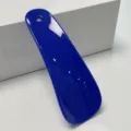 Blue plastic shoehorn for easy wear, portable hanging shoe helper tool for daily use. - Blue