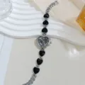 Chic γυναικείο ρολόι χαλαζία με καντράν καρδιάς και μαύρους κρυστάλλινους συνδέσμους. - Ασημί Μαύρο