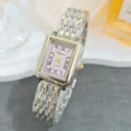 Close-up detail of vintage rectangular women quartz watch with pink dial and Roman numerals. - Two Tone Gold Pink