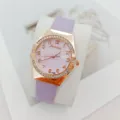 Close-up detail of the women quartz watch with purple leather strap and rhinestone bezel. - Purple