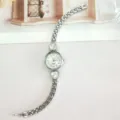 Detailed view of women silver quartz watch with heart crystal design on sleek strap. - Silver White