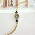 Elegant gold quartz watch for women featuring chic black heart stone accents and slim bracelet strap. - Gold Black