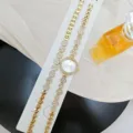 Gold rhinestone ladies quartz watch detail shot, elegant floral design bracelet set showcase. - Watch and Bracelet Set / Gold White