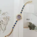 Elegante reloj de pulsera de cuarzo para mujer con pedrería de lágrima azul y correa de metal dorado. - Azul