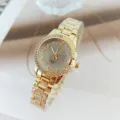 Montre quartz femme ton doré avec lunette strass et cadran texturé pour élégance. - Gris Doré