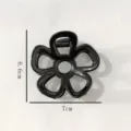 Close-up detail view of the black geometric flower hair claw clip, highlighting size. - Glossy Floral Hair Claw(Z1565) / 7cm / Black