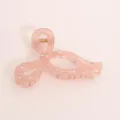 Close-up detail of pink translucent bow hair claw with sparkling rhinestones and metal spring. - Pink