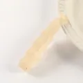 Detail view of the translucent jelly banana hair clip in light beige with wavy minimalist design. - Glossy Jelly White