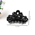 Close-up detail view of the black flower hair claw clip, showing its glossy finish and size. - Floral Hair Claw (Z1204)