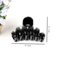Close-up detail of the elegant black hair claw clip, showing its unique spiral design and size. - Spiral Hair Claw (Z1284)